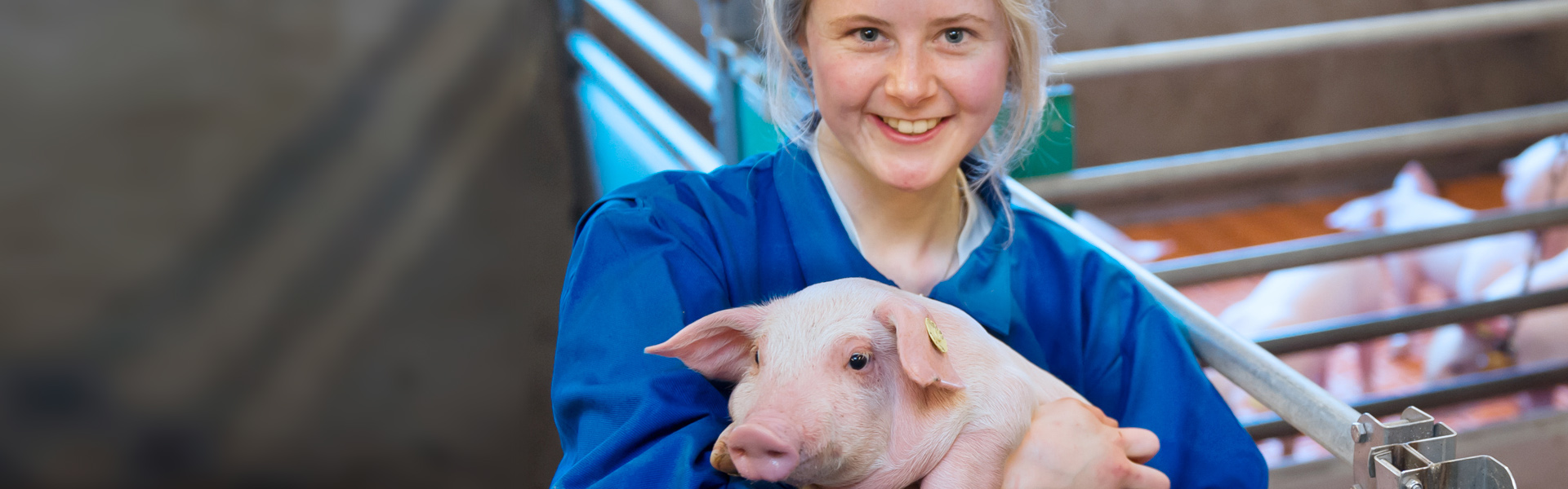 Woman with a piglet in her arms