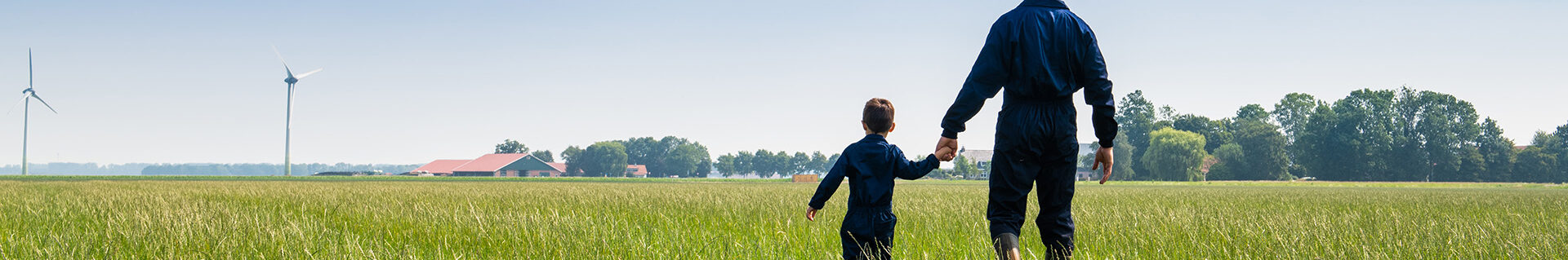 father and son walking in grassland