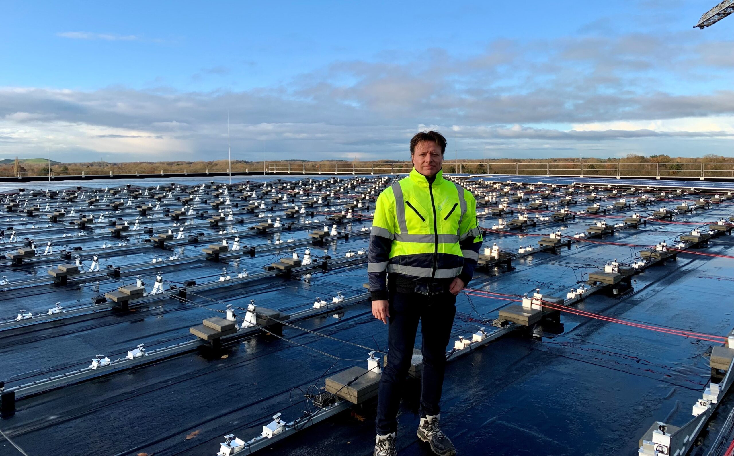 Worker on a roof to install solar panels